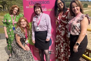 Healthwatch team in front of banner