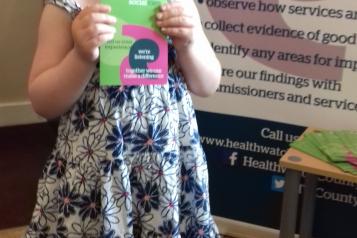 Girl with Healthwatch Leaflet