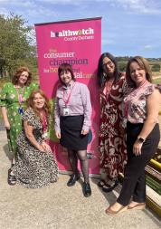 Healthwatch team in front of banner