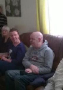 People sat on sofa in care home